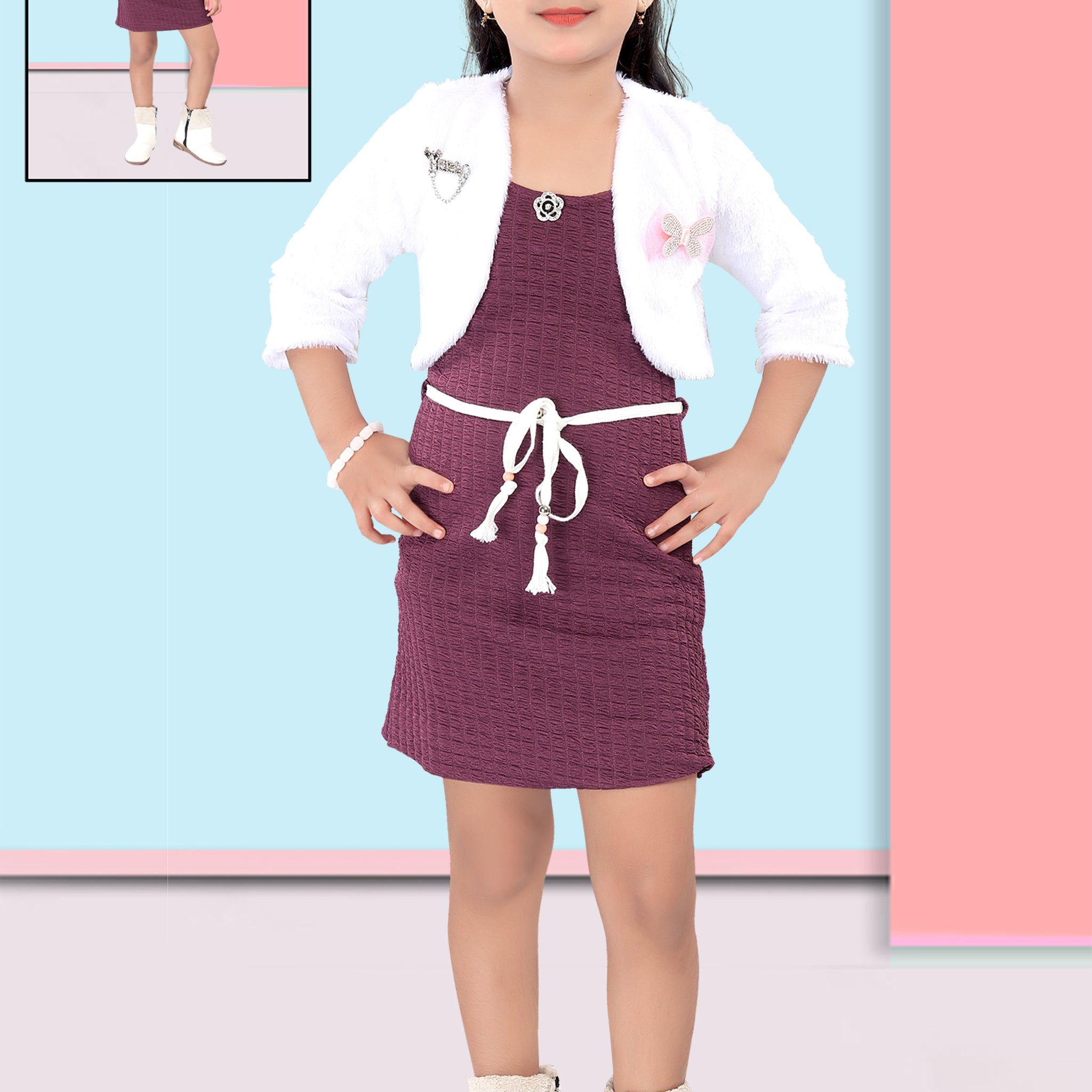 Girl wearing a maroon dress with a white jacket and sunglasses, standing against a colorful background.