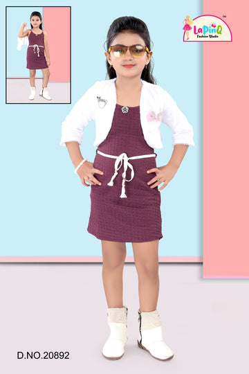 Girl wearing a maroon dress with a white jacket and sunglasses, standing against a colorful background.