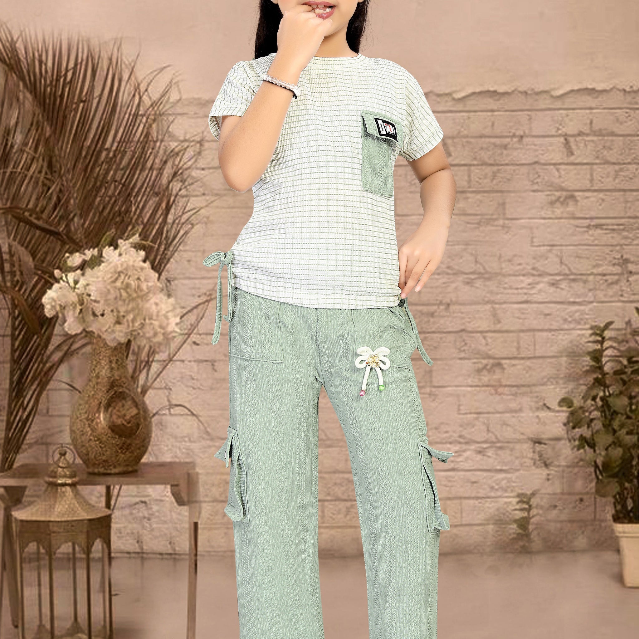 Young girl wearing a white and green outfit co-ord set cod set
