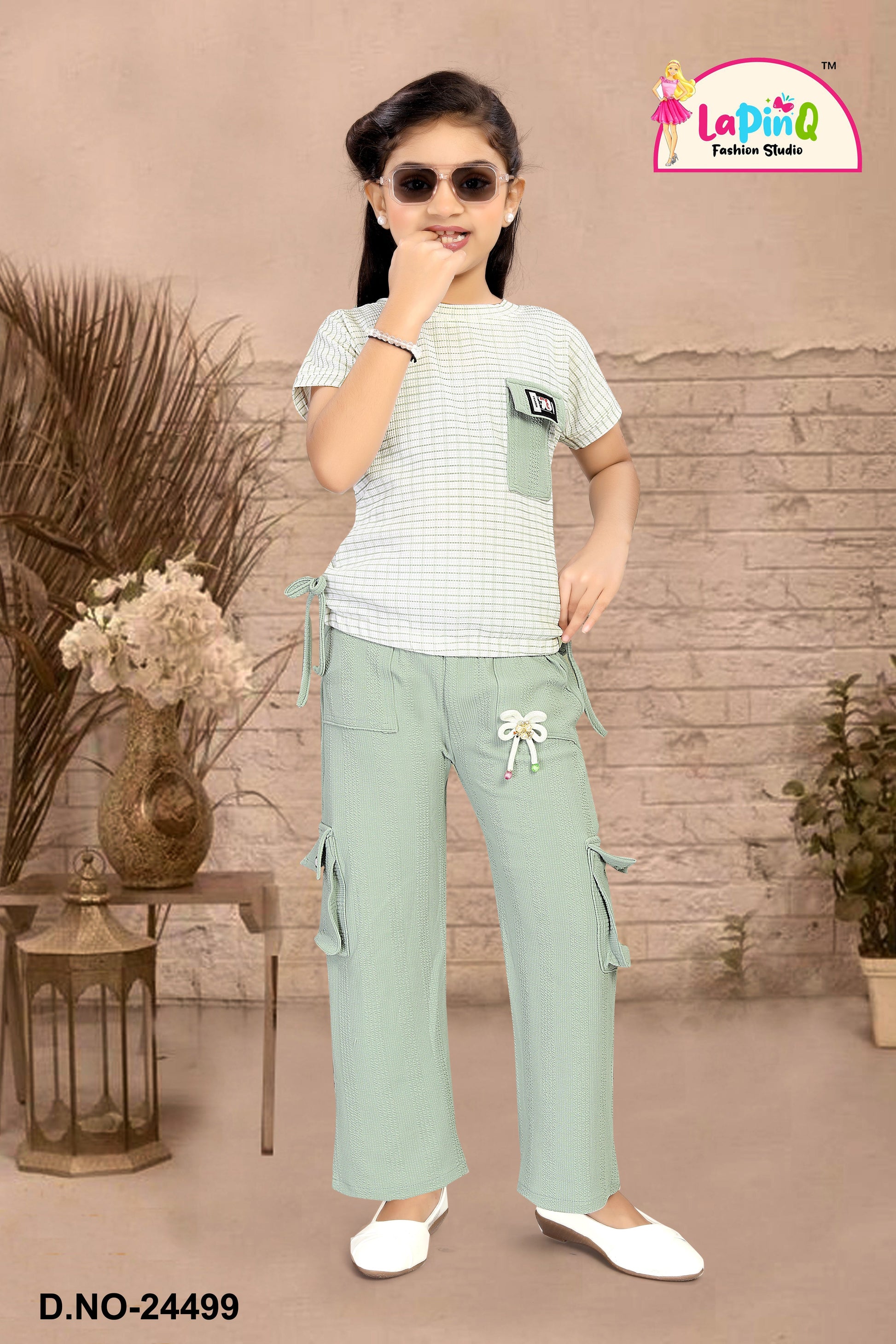 Young girl wearing a white and green outfit co-ord set cod set